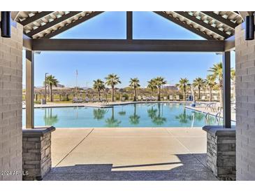Community pool with lounge chairs and palm trees at 5837 N 89Th Dr, Glendale, AZ 85305