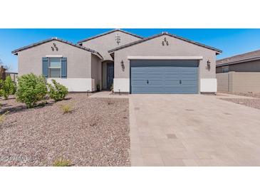 Modern two-story home with gray garage door and landscaping at 3454 E Jasmine Way, San Tan Valley, AZ 85143