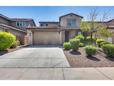 Two story home with attached garage and landscaped front yard at 12219 W Prickly Pear Trl, Peoria, AZ 85383