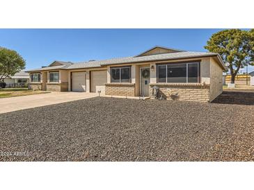 Front view of charming house with double garage and gravel landscaping at 10418 N 97Th Dr # B, Peoria, AZ 85345