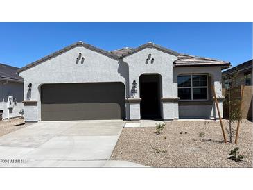 Modern two-car garage home with desert landscaping at 40170 W Hillman Dr, Maricopa, AZ 85138