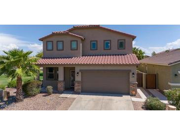 Two-story house with a large garage and palm trees at 42331 W Somerset Dr, Maricopa, AZ 85138