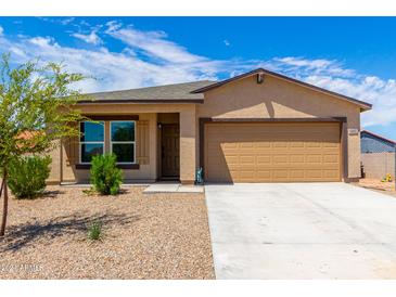 Tan single-story house with two-car garage and desert landscaping at 14852 S Diablo Rd, Arizona City, AZ 85123