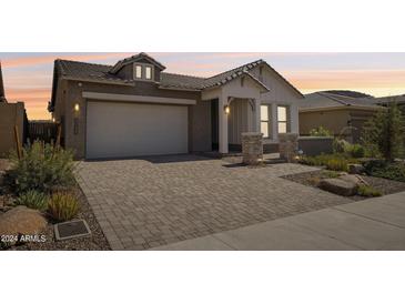 Craftsman style home with a two-car garage and landscaped front yard at 13190 W Horsetail Trl, Peoria, AZ 85383