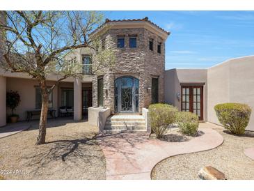 Stone exterior of a house with a courtyard and entrance at 8876 S Santa Elizabeth Dr, Goodyear, AZ 85338