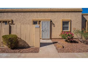 Tan stucco building with a security door and walkway at 1331 E Pierson St, Phoenix, AZ 85014