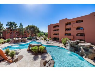Community pool with waterfall feature at 4303 E Cactus Rd # 441, Phoenix, AZ 85032