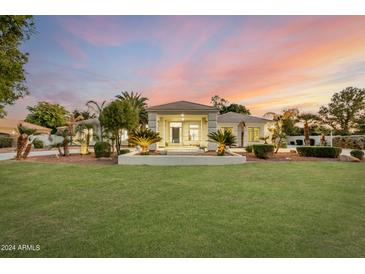 Stunning one-story home with a beautiful landscaped yard at sunset at 19555 E Via Del Oro --, Queen Creek, AZ 85142