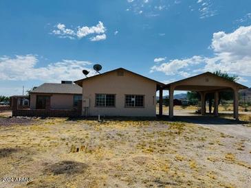 Ranch-style home with carport and large backyard at 51631 W Turney Ln, Maricopa, AZ 85139