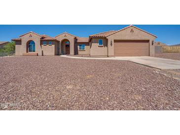 Two-story home with attached garage and desert landscaping at 32120 N 167Th Ave, Surprise, AZ 85387