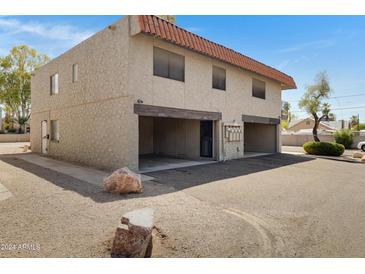 Front view of a two-story building with parking and landscaping at 1205 N 47Th Pl, Phoenix, AZ 85008