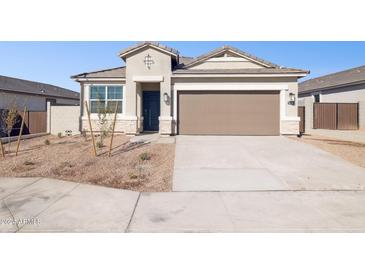 Single story home with two car garage and desert landscaping at 5420 S 253Rd Ln, Buckeye, AZ 85326