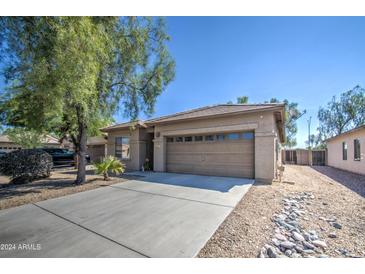 Single-story home with a two-car garage and desert landscaping at 913 S 115Th Dr, Avondale, AZ 85323