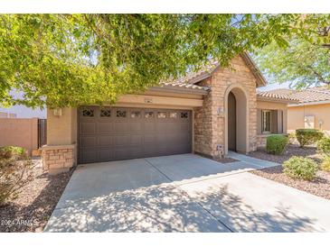 House exterior with stone accents and 2 car garage at 22165 W Shadow Dr, Buckeye, AZ 85326