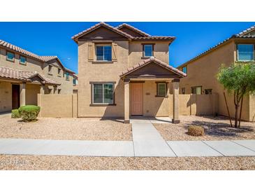 Two-story stucco home with a terracotta tile roof, shutters, and a welcoming front porch at 824 E Agua Fria Ln, Avondale, AZ 85323