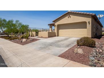 Single-car garage with desert landscaping and driveway at 17540 W Glenhaven Dr, Goodyear, AZ 85338