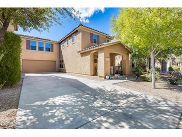 Two-story house with attached garage and landscaping at 18535 W Udall Dr, Surprise, AZ 85374