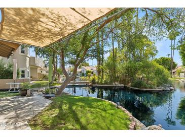 Patio area with canal view and shade structure at 514 S Marina Dr, Gilbert, AZ 85233