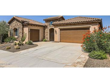 Two-story home with stone elevation and desert landscaping at 26562 W Vista North Dr, Buckeye, AZ 85396