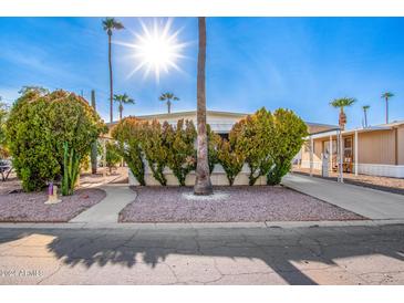Mobile home exterior with landscaping and a paved walkway at 2650 W Union Hills Dr # 114, Phoenix, AZ 85027