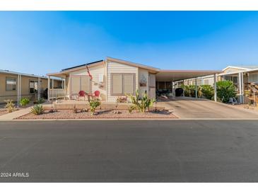 Single-story home with carport and desert landscaping at 11596 W Sierra Dawn Blvd # 377, Surprise, AZ 85378