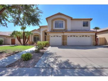 Two-story house with a three-car garage and landscaping at 695 W Estrella Dr, Gilbert, AZ 85233