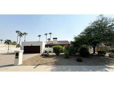 Single-story home with attractive landscaping and gated entry at 6439 E Camino Santo Dr, Scottsdale, AZ 85254