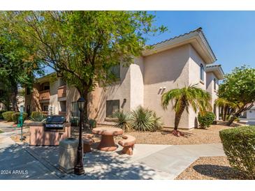 Building exterior with BBQ and seating area at 10030 W Indian School Rd # 221, Phoenix, AZ 85037