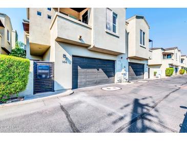Attached garage with modern dark gray doors and gated entry at 4216 N 27Th St # 106, Phoenix, AZ 85016