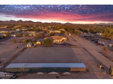 Aerial view of a property with a house, arena, stables and surrounding land at 39029 N 21St Ave, Phoenix, AZ 85086