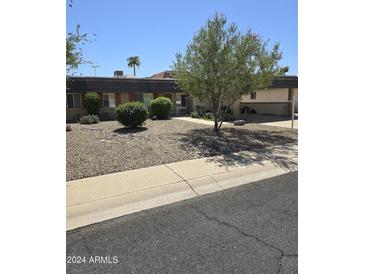 Ranch style home with gravel landscaping and driveway at 10617 W Deanne Dr, Sun City, AZ 85351