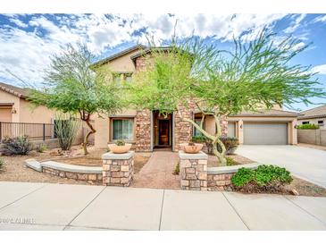 Two-story house with stone accents and landscaped front yard at 26886 N 90Th Ave, Peoria, AZ 85383