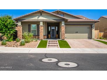 Beautiful home with stone accents and a welcoming front entrance at 28001 N 92Nd Ave, Peoria, AZ 85383