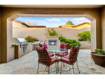 Outdoor patio with fireplace, seating area, and built-in grill at 3129 S Honeysuckle Ct, Gold Canyon, AZ 85118