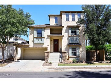 Three-story home with a two-car garage and stonework at 4306 E Tyson St, Gilbert, AZ 85295