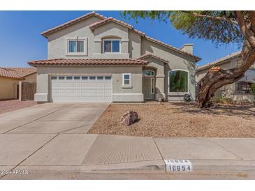 Two-story home with attached garage and landscaping at 10654 E Forge Ave, Mesa, AZ 85208