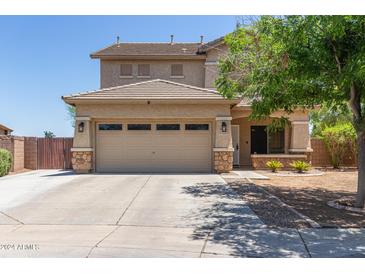 Two-story house with a two-car garage and neutral color scheme at 21623 N Gibson Dr, Maricopa, AZ 85139