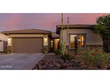 Single-story home with a two-car garage and desert landscaping at 18211 W Sequoia Dr, Goodyear, AZ 85338