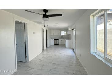 Remodeled kitchen with white shaker cabinets, stainless steel appliances, and quartz countertops at 568 N Sirrine --, Mesa, AZ 85201