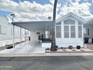 Single wide manufactured home with carport and landscaping at 155 S Limestone Dr, Apache Junction, AZ 85119