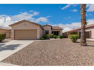 Tan house with brown garage door and desert landscaping at 1940 S Talbot Cir, Mesa, AZ 85209