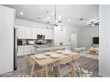 Open concept kitchen and dining area with modern cabinetry and island at 901 S Smith Rd # 1012, Tempe, AZ 85281