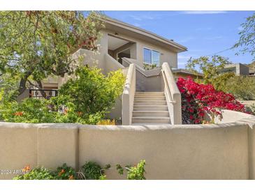 Two story home with stucco exterior, landscaping, and stairs at 8420 N 15Th St, Phoenix, AZ 85020
