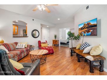 Bright living room featuring hardwood floors and comfy seating at 6900 E Princess Dr # 1136, Phoenix, AZ 85054