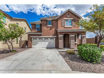 Two-story house with a large driveway and landscaping at 7311 N 90Th Ave, Glendale, AZ 85305