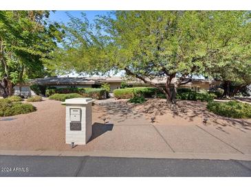 Front view of a single story home with mature landscaping at 6516 E Maverick Rd, Paradise Valley, AZ 85253