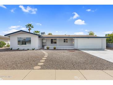 Charming ranch-style home with a well-maintained front yard at 6027 E Duncan St, Mesa, AZ 85205