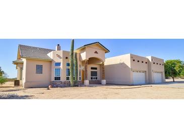 Two-story house with stucco exterior and a three-car garage at 19999 W Fawny Ln, Casa Grande, AZ 85122