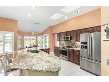 Spacious kitchen with granite countertops and stainless steel appliances at 15316 W Sky Hawk Dr, Sun City West, AZ 85375