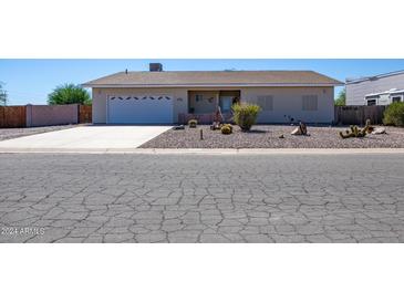 Ranch-style home with a single-car garage and well-maintained landscaping at 8183 W Raven Dr, Arizona City, AZ 85123